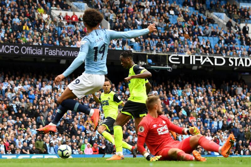 Terence Kongolo of Huddersfield Town scores an own goal for Manchester City's sixth goal. Getty Images