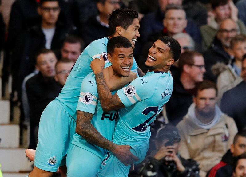 Newcastle United's Kenedy celebrates scoring their first goal with DeAndre Yedlin and Muto. Reuters