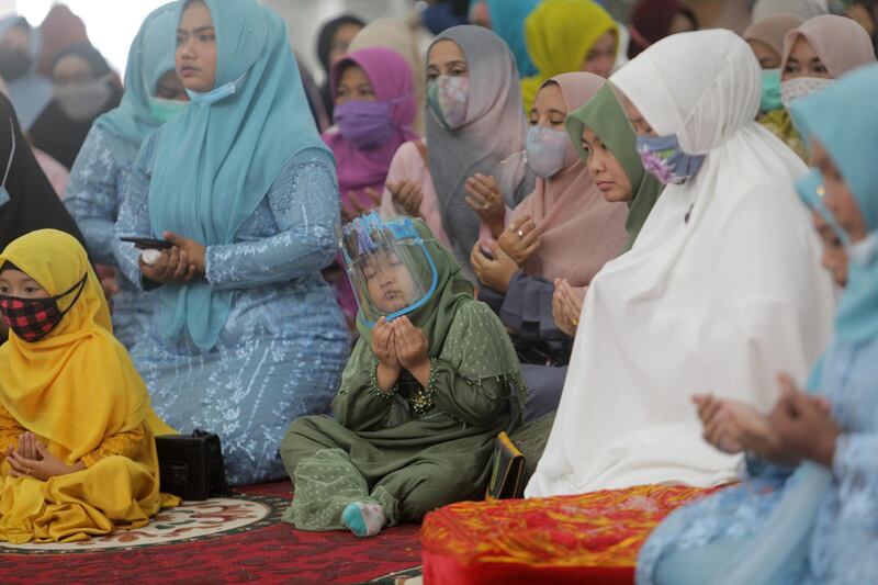 Bride and groom's family members attend a wedding ceremonyin Banda Aceh, Indonesia. EPA
