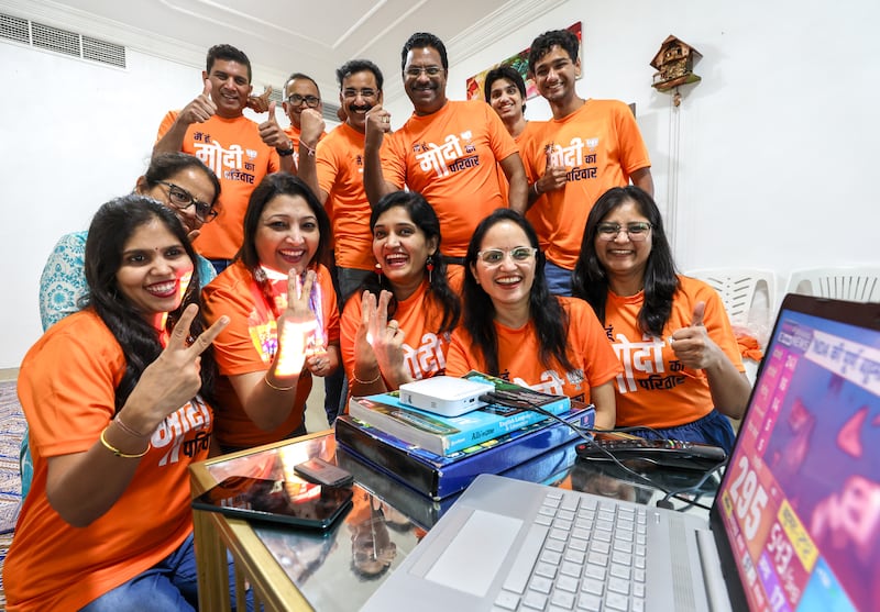 BJP supporters in Abu Dhabi celebrate while watching the election counting in India as Narendra Modi leads by a small margin. Victor Besa / The National