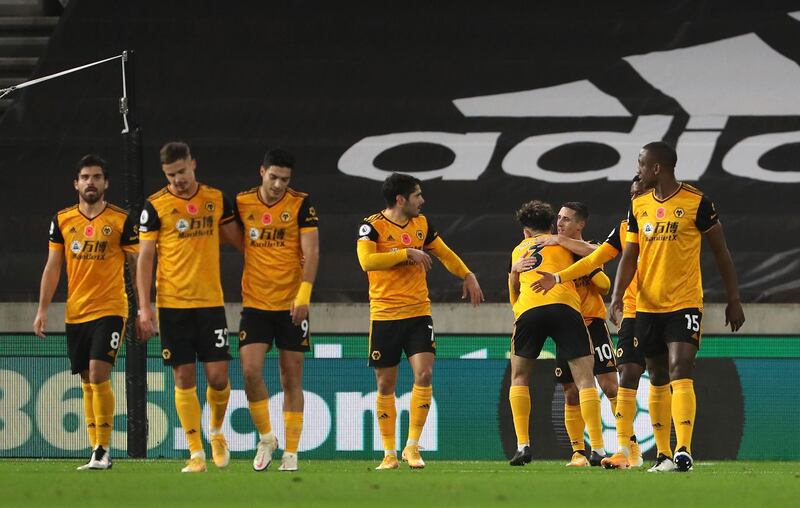WOLVERHAMPTON, ENGLAND - OCTOBER 30: Daniel Podence of Wolverhampton Wanderers celebrates with teammates after scoring his team's second goal during the Premier League match between Wolverhampton Wanderers and Crystal Palace at Molineux on October 30, 2020 in Wolverhampton, England. Sporting stadiums around the UK remain under strict restrictions due to the Coronavirus Pandemic as Government social distancing laws prohibit fans inside venues resulting in games being played behind closed doors. (Photo by Geoff Caddick - Pool/Getty Images)
