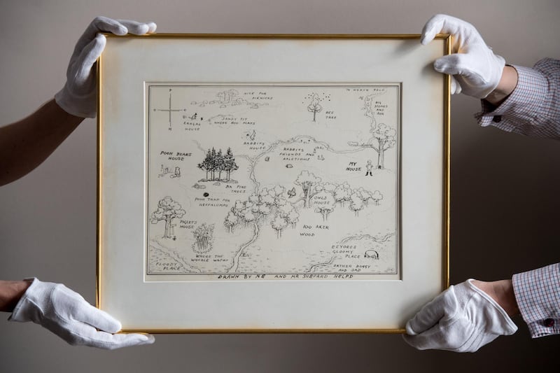 LONDON, ENGLAND - MAY 31:  Sotheby's art handlers hold 'The Original Map of the Hundred Acre Wood' by E.H. Shepard, estimated at £100,000 to £150,000, at the unveiling of original Winnie-The-Pooh sketches at Sotheby's on May 31, 2018 in London, England.  The map has been unseen for almost half a century and is up for sale alongside four further long hidden original Winnie-The-Pooh illustrations at Sotheby's London on 10th July 2018.  (Photo by Chris J Ratcliffe/Getty Images for Sotheby's)