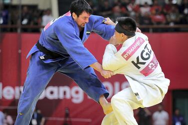 Victor Scvortov, in blue, on his way to win the judo bronze medal from Bettor Rysmambetov of Kyrgyzstan at the Asian Games in Jakarta. UAENOC