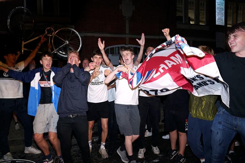 Fulham fans celebrate outside Craven Cottage. PA