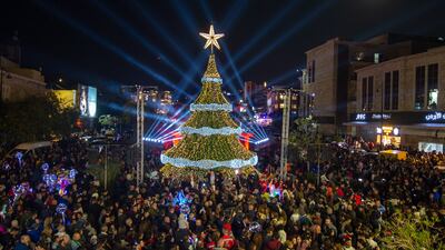 People gather round a n impressive Christmas tree in Byblos, Lebanon. EPA