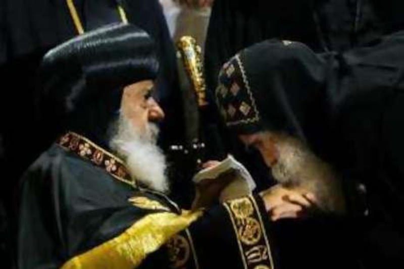 An Egyptian monk kisses the hand of Pope Shenouda III, the ailing head of Egypt's Coptic Orthodox Church, before he gives a sermon at Cairo's St. Mark's cathedral, Egypt, Wednesday, Oct. 22, 2008, the first in four months following his return from the United States where he had surgery to repair a broken thigh bone suffered in a fall at his Cairo home. The Coptic community makes up about 10 percent of Egypt's population of 77 million. It is the largest Christian community in the Middle East.(AP Photo/Amr Nabil)  *** Local Caption ***  XAN104_MIDEAST_EGYPT_Pope_.jpg