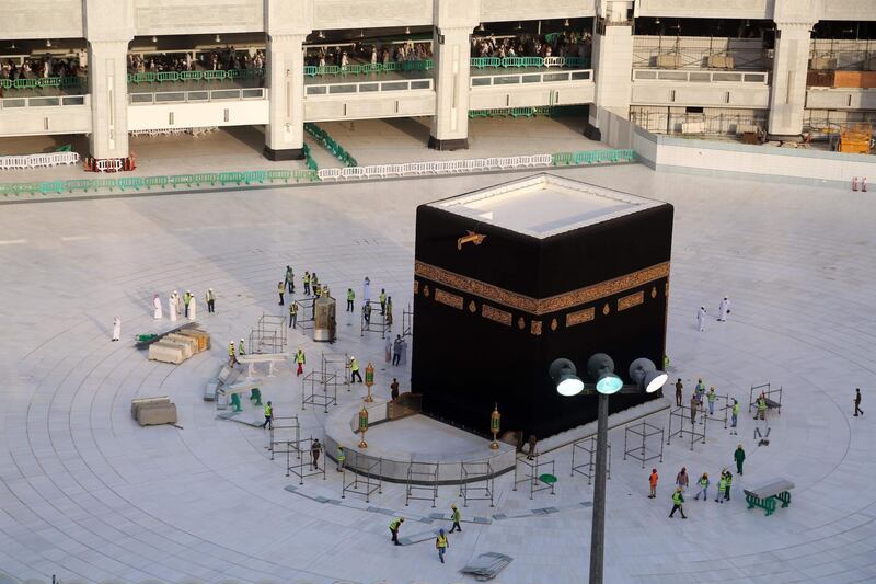 Municipal workers are seen in empty courtyard the Kaaba. AFP