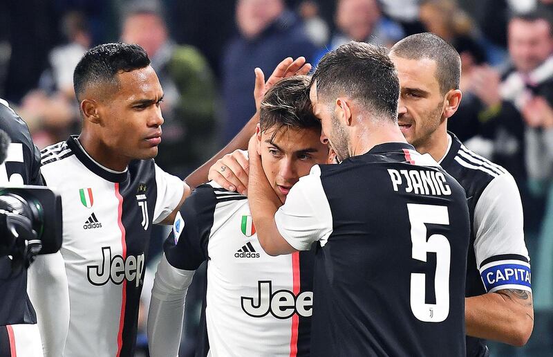 epa07986985 Juventus' Paulo Dybala (2-L) celebrates with teammates after scoring the 1-0 lead during the Italian Serie A soccer match between Juventus FC and AC Milan in Turin, Italy, 10 November 2019.  EPA/ALESSANDRO DI MARCO