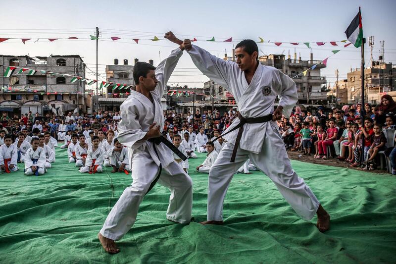 Young Palestinian karatekas demonstrate their skills during a Karate promotion ceremony at a sporting centre in the Rafah camp for Palestinian refugees in the southern Gaza Strip.   AFP