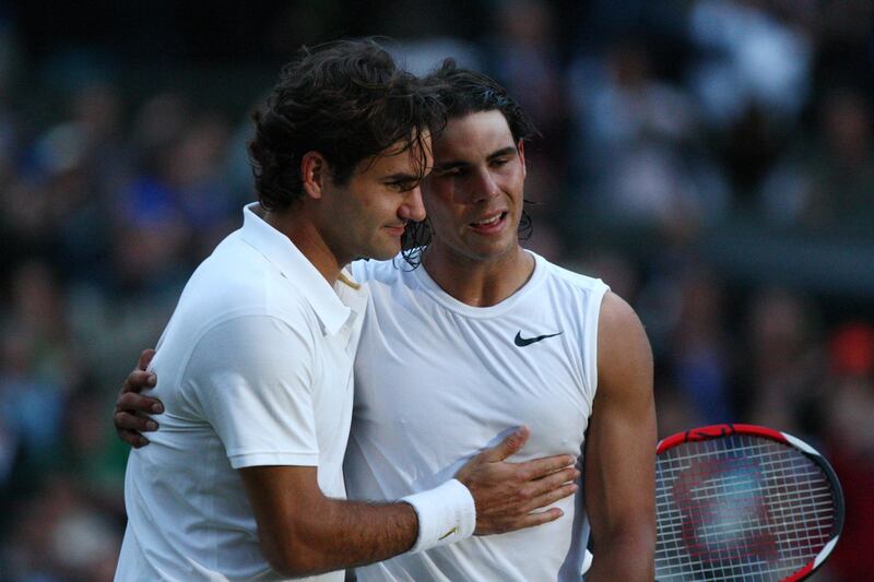 (FILES) In this file photo taken on July 6, 2008 Spain's Rafael Nadal (R) is congratulated by Switzerland's Roger Federer after winning their final tennis match of the 2008 Wimbledon championships at The All England Tennis Club in southwest London. Roger Federer and Rafael Nadal meet for the fourth time at Wimbledon on July 12, 2019 in the semi-finals, 11 years after their last clash at the All England Club. / AFP / POOL / RYAN PIERSE
