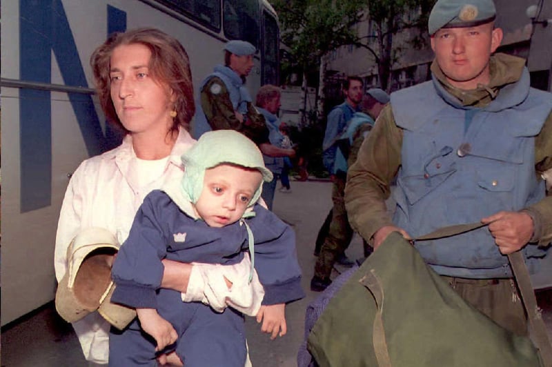Amra Husic carries her one-year-old child Jasmin, who was suffering from malnutrition, into Sarajevo's Kosevo hospital after both were evacuated alongside 20 other people by Norwegian UN soldiers out of the eastern Muslim enclave of Srebrenica, Bosnia and Herzegovina, May 4, 1995. EPA