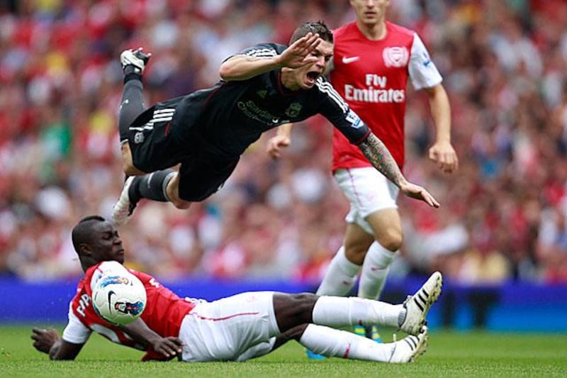 Arsenal youngster Emmanuel Frimpong sends the Liverpool defender Daniel Agger flying with a late challenge. Frimpong was sent off to compound a miserable day for Arsenal.


Stefan Wermuth / Reuters