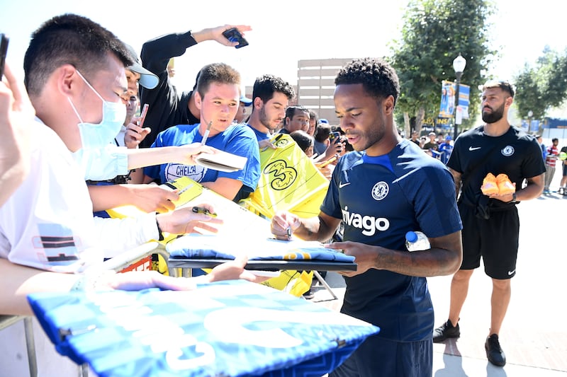 Raheem Sterling signs autographs before a training session at Drake Stadium in Los Angeles, California.