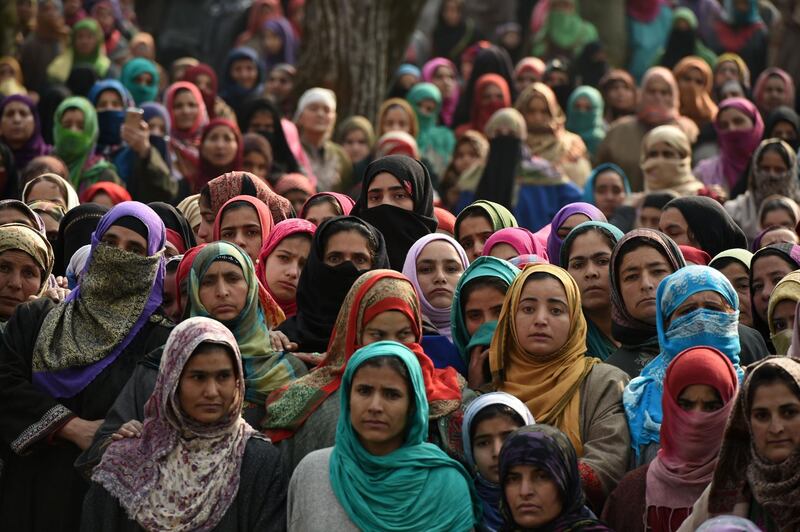 Kashmiri villagers look on during a funeral of Fardeen Ahmad Khandey, 16, in Tral area of South Kashmir. Suspected rebels stormed a paramilitary camp in Indian-administered Kashmir, early on January 1 leaving eight dead.  Tauseef Mustafa / AFP Photo