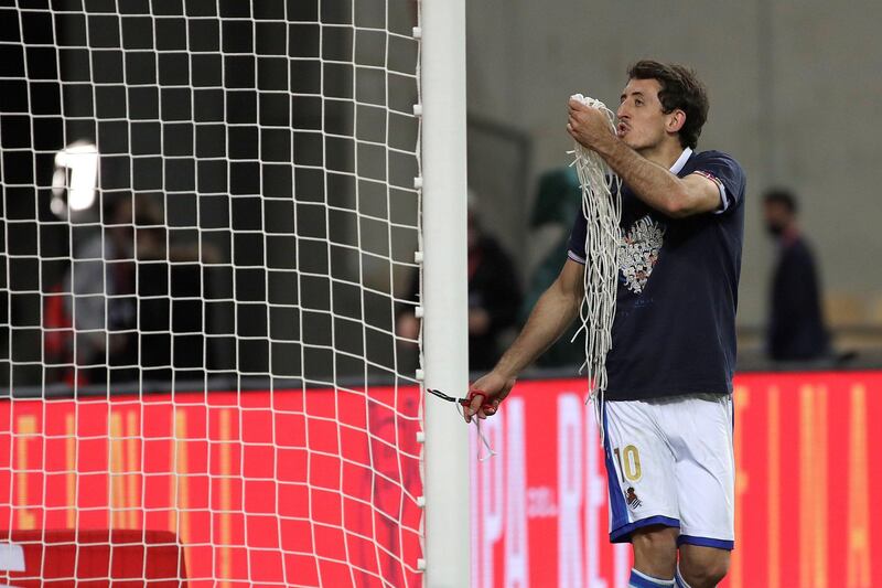Real Sociedad's winger Mikel Oyarzabal cuts the goal net after winning the 2020 Copa del Rey. EPA