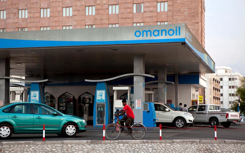 A man passes an Oman Oil gas station in Muscat, the capital of the Sultanate of Oman on Wednesday, Oct. 12, 2011. (Silvia Razgova/The National)

