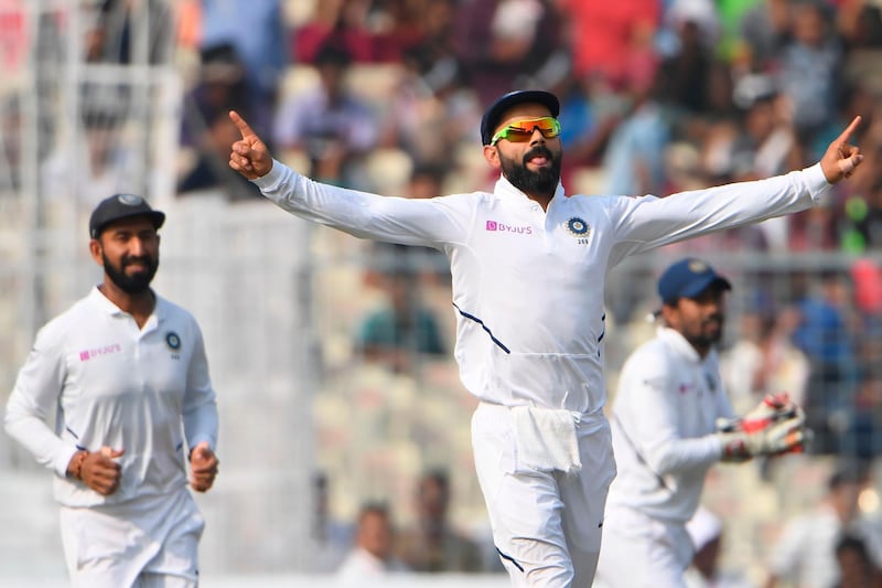 India's cricket team captain Virat Kohli (R) celebrates after winning the match during the third day of the second Test cricket match of a two-match series between India and Bangladesh at the Eden Gardens cricket stadium in Kolkata on November 24, 2019. IMAGE RESTRICTED TO EDITORIAL USE - STRICTLY NO COMMERCIAL USE
 / AFP / Dibyangshu SARKAR / IMAGE RESTRICTED TO EDITORIAL USE - STRICTLY NO COMMERCIAL USE
