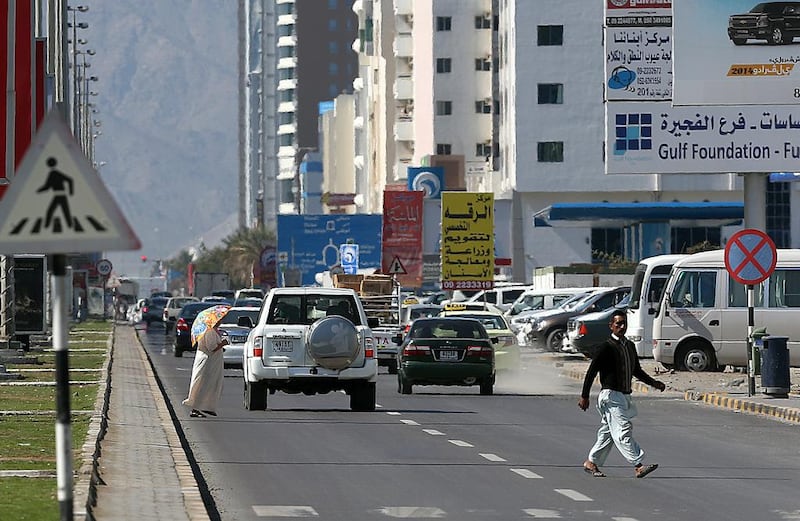 Pedestrians cross the Hamad Bin Abdullah Street section of the E99 ‘death road’ in Fujairah. Satish Kumar / The National