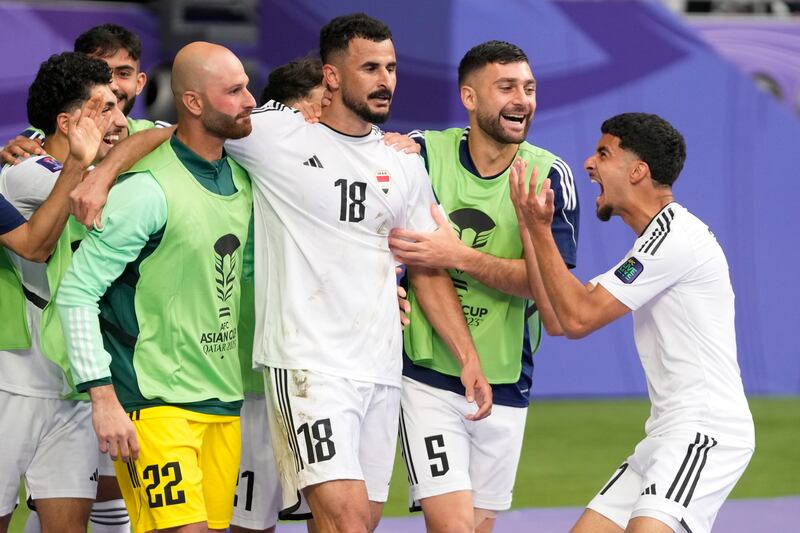 Iraq's Aymen Hussein, centre, celebrates after scoring his side's second goal. AP