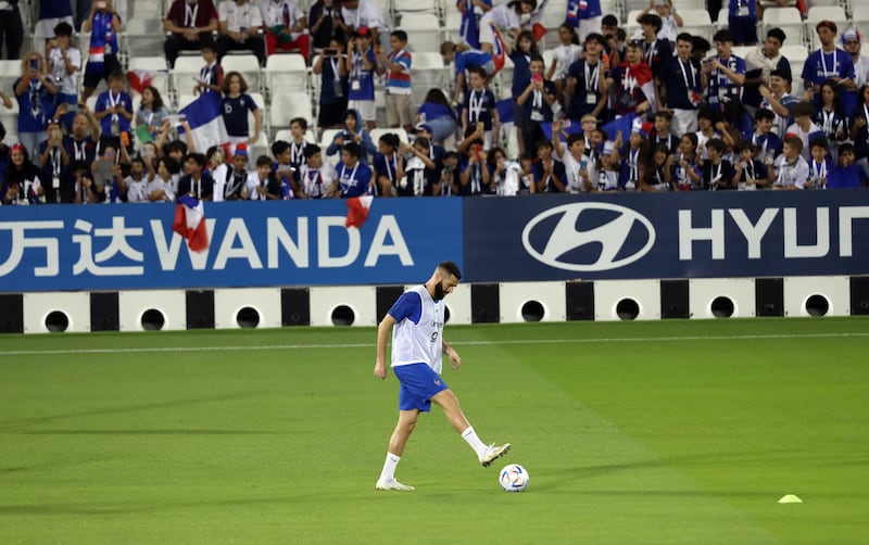 Fans in Doha watch Karim Benzema at the France training session. EPA