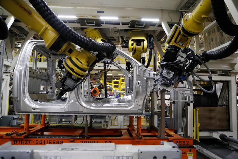 FILE- In this Sept. 27, 2018, file photo robots weld the cab of a 2018 Ford F-150 truck on the assembly line at the Ford Rouge assembly plant in Dearborn, Mich. On Thursday, Nov. 1, the Institute for Supply Management, a trade group of purchasing managers, issues its index of manufacturing activity for October. (AP Photo/Carlos Osorio, File)