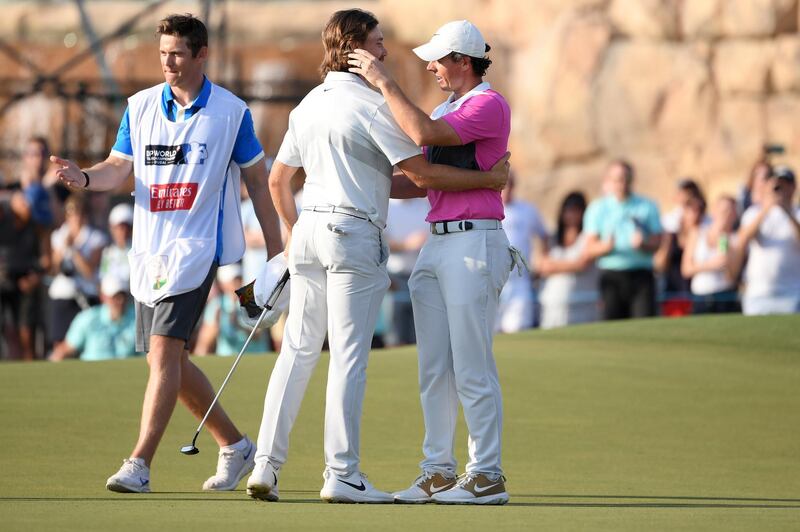 Tommy Fleetwood and Rory McIlroy embrace on the 18th green. Getty