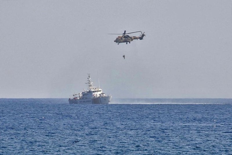 A handout picture released by the Turkish Armed Forces on September 6, 2020 shows a soldier hanging from a helicopter during a military exercise in the self-proclaimed Turkish Republic of Northern Cyprus. (Photo by Handout / TURKISH ARMED FORCES / AFP) / RESTRICTED TO EDITORIAL USE - MANDATORY CREDIT "AFP PHOTO / TURKISH ARMED FORCES" - NO MARKETING NO ADVERTISING CAMPAIGNS - DISTRIBUTED AS A SERVICE TO CLIENTS