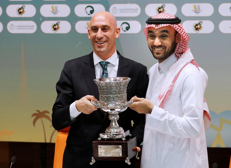 Luis Rubiales, left, and Prince Abdulaziz bin Turki Al-Faisal pose with the Spanish Super Cup trophy. AP Photo