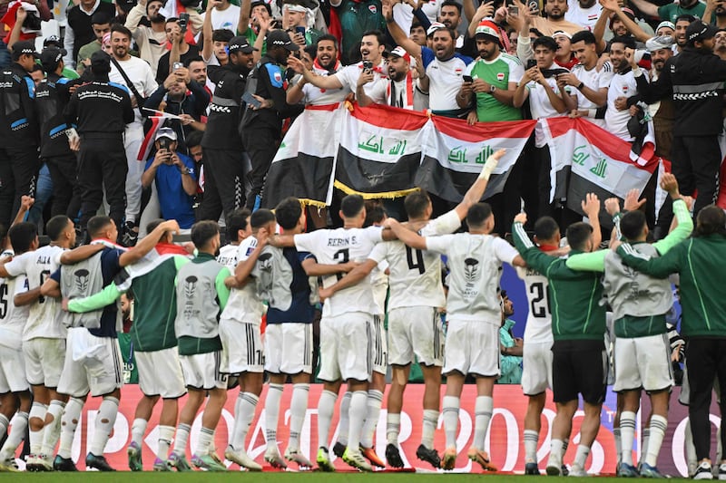 Iraq players celebrate in front of their fans after the match. AFP