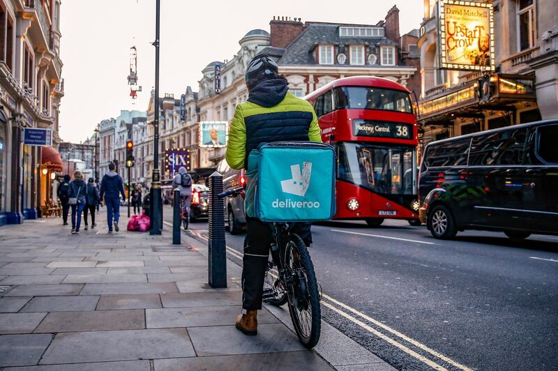 A takeaway food courier, working for Deliveroo, operated by Roofoods Ltd., cycles in the Soho district of London, U.K., on Tuesday, Sept. 29, 2020. Covid-19 lockdown enabled online and app-based grocery delivery service providers to make inroads with customers they had previously struggled to recruit, according the Consumer Radar report by BloombergNEF. Photographer: Hollie Adams/Bloomberg via Getty Images