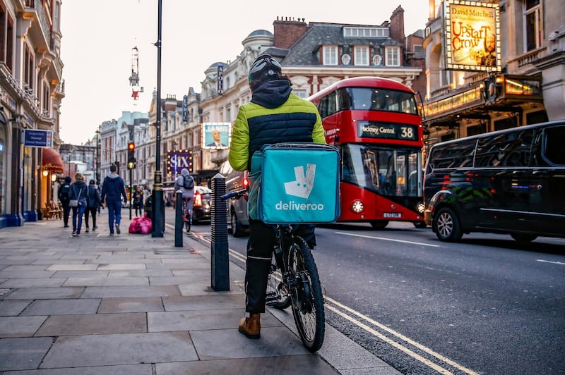 A takeaway food courier, working for Deliveroo, operated by Roofoods Ltd., cycles in the Soho district of London, U.K., on Tuesday, Sept. 29, 2020. Covid-19 lockdown enabled online and app-based grocery delivery service providers to make inroads with customers they had previously struggled to recruit, according the Consumer Radar report by BloombergNEF. Photographer: Hollie Adams/Bloomberg via Getty Images