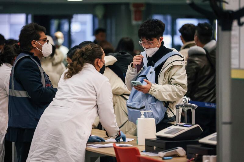 Passengers arriving from China are tested for Covid-19 at Milan Malpensa Airport, Italy, on December 29. LaPresse via AP