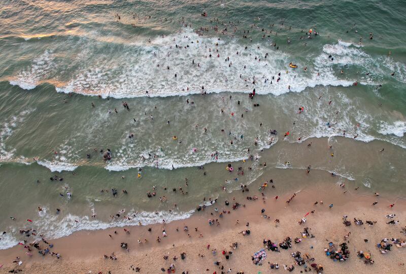 People enjoy a hot day on the beach in Gaza City. Reuters