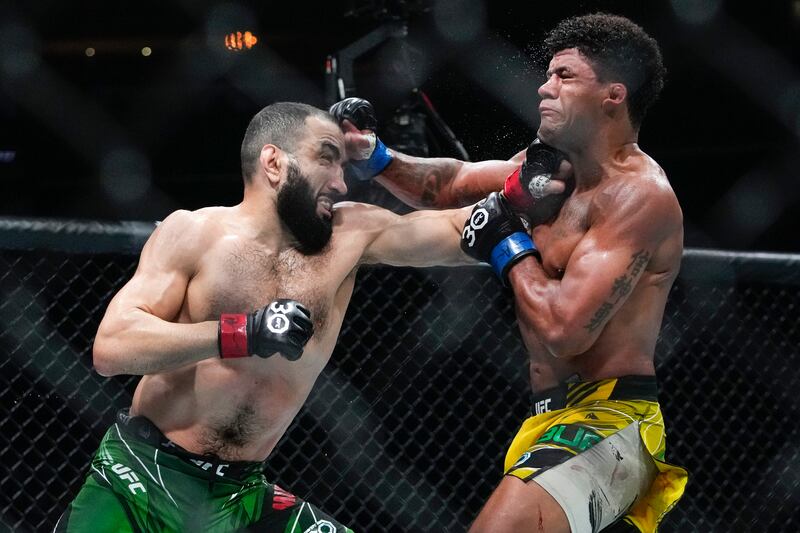 Belal Muhammad and Gilbert Burns exchange punches during the fifth round. AP