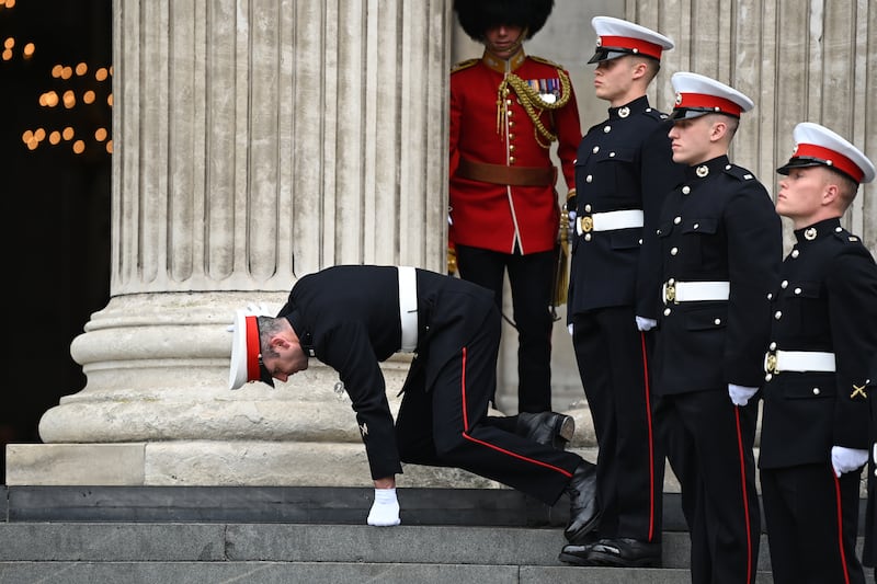 A member of the military guard of honour collapses outside St Paul's Cathedral, ahead of the service of thanksgiving. PA 
