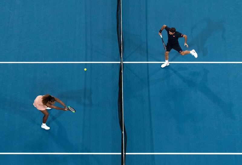 Serena Williams, left, (L) of the USA and Roger Federer of Switzerland in action during the mixed doubles match. EPA