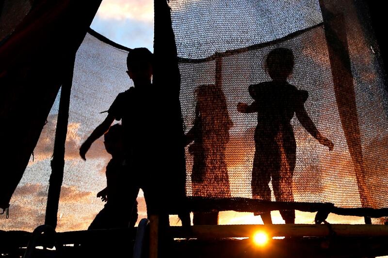 Palestinian children play near the beach at sunset in Gaza City. AFP