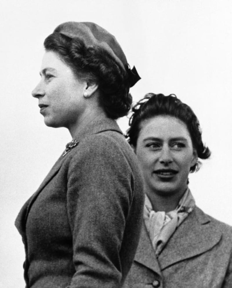 Britain’s Queen Elizabeth II and Princess Margaret, right, as they look in different directions, as they attend the West Norfolk hunt point-to-point races at Sporle, England on April 30, 1955. AP Photo file