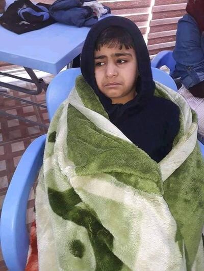 A young boy is wrapped up in a towel after being rescued from the Tigris after a ferry capsizing near Mosul. Photo courtesy Civil Defence Nineveh Press via Storyful