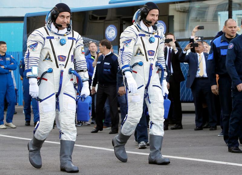 Alexey Ovchinin and Nick Hague make their way to the launch. EPA