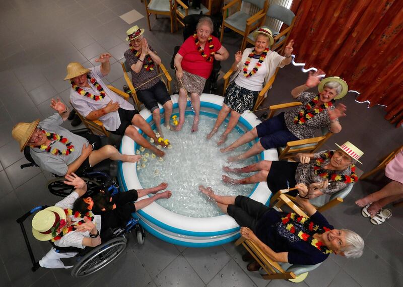 Residents at the Ter Biest house for elderly persons refresh their feet in a pool on a hot summer day, in Grimbergen, Belgium, August 3, 2018. REUTERS/Yves Herman      TPX IMAGES OF THE DAY