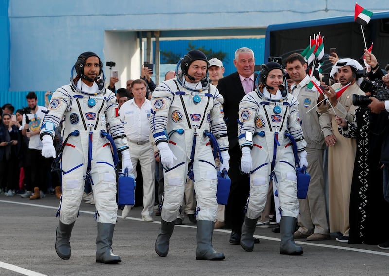 ISS crew members Jessica Meir of the US, Oleg Skripochka of Russia and Hazza Al Mansouri of the UAE walk to the launchpad at the Baikonur Cosmodrome, Kazakhstan. Shamil Zhumatov / Reuters