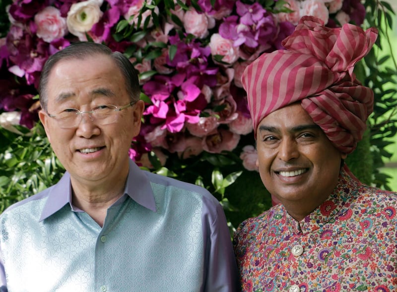 Reliance Industries Chairman Mukesh Ambani stands for a photograph with former U.N. Secretary-General Ban Ki-moon. Photo: AP