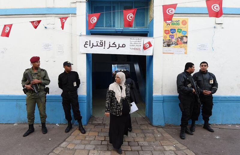 Tunisian security officers stand guard outside at a polling station in Tunis, on November 23, 2014, during Tunisia's first presidential election since the 2011 revolution. Fadel Senna/AFP Photo 