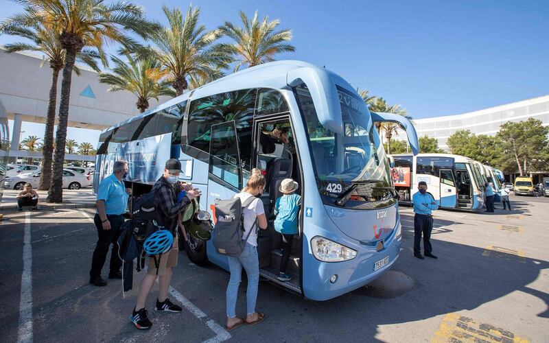 Tourists board a bus at Son Sant Joan airport in Palma de Mallorca. AFP