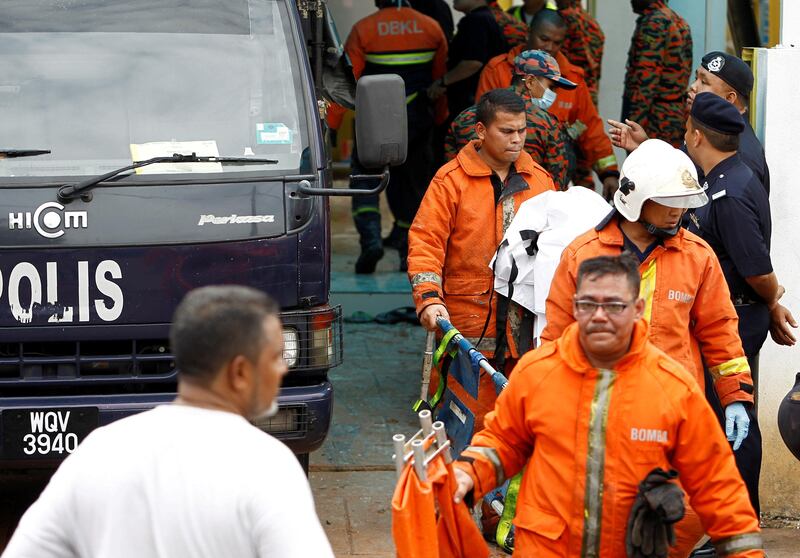 Firefighters leave religious school Darul Quran Ittifaqiyah after a fire broke out in Kuala Lumpur, Malaysia. Lai Seng Sin / Reuters