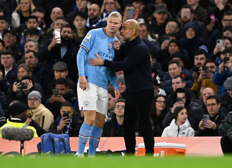 Manchester City manager Pep Guardiola gives instructions to Erling Haaland on the touchline. Reuters