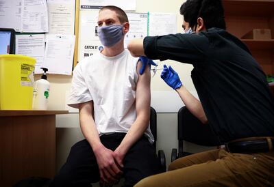 A dose of the Pfizer/BioNTech vaccine is administered in London, with full vaccination set to become a requirement for entry to certain places. Reuters 