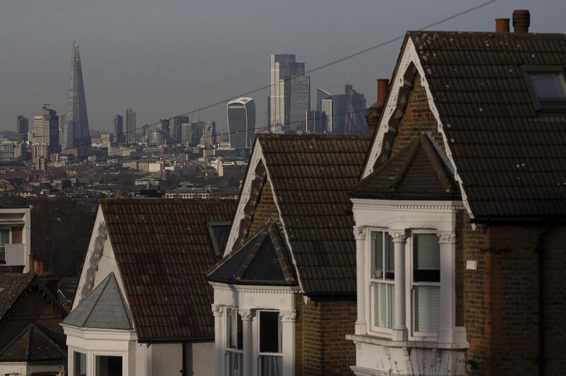 A terrace of residential houses in the Dulwich district in view of skyscrapers in the City of London, U.K., on Tuesday, Nov. 24, 2020. Asking prices for U.K. homes slipped this month as owners sought to get sales agreed in time to benefit from a temporary tax cut. Photographer: Simon Dawson/Bloomberg Photographer: Simon Dawson/Bloomberg
