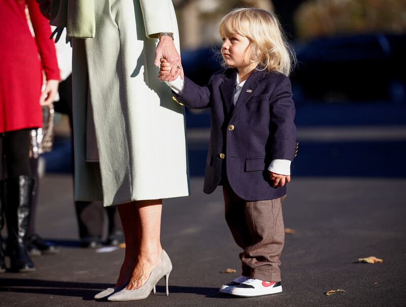 Beau Biden, son of Hunter Biden, holds his grandmother's hand as she receives the tree. Reuters